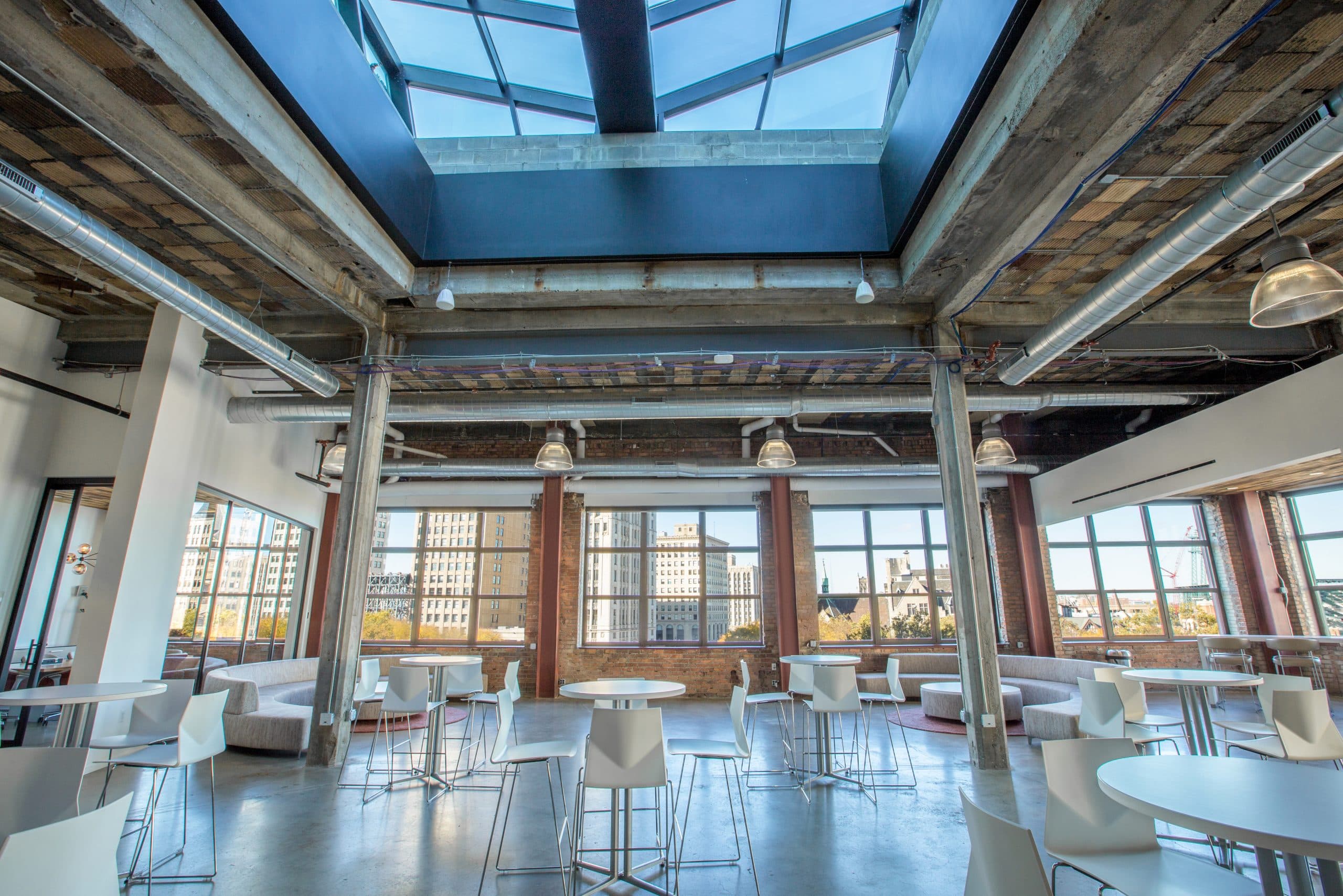 The Madison Loft set with high top tables, two half round couches and coffee tables with views of Woodward.